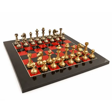 Complete chess set with gold and silver brass pieces on a red and black board