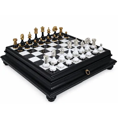 Brass chess set with gold and silver plating on black marble chess board