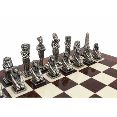 Egypt chess pieces in silver-toned metal viewed from the front on the board