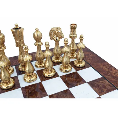 Close-up of gold pieces, finely engraved knight and rook on the chessboard