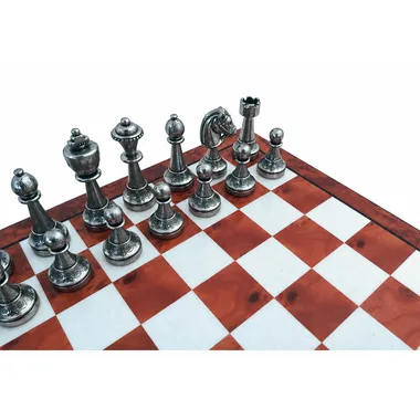 Silver-tone Staunton pieces close-up on the marquetry chess board