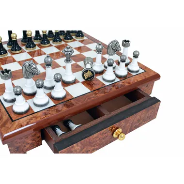 Open wooden drawer with Staunton chess pieces on the board