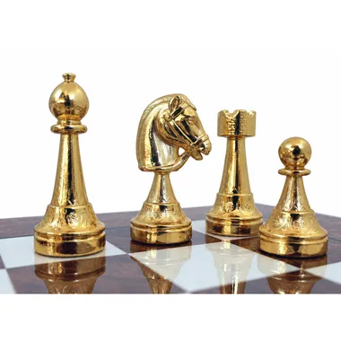 Close-up of gold-plated pieces: bishop, knight, rook and pawn on the board