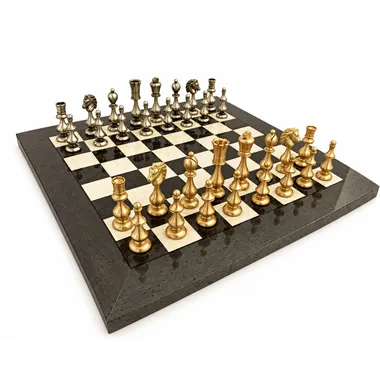Complete chess set in gold and silver brass on a grey wooden board