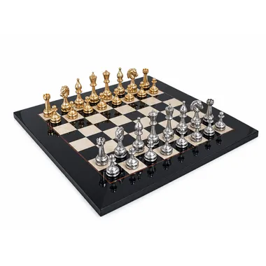 Complete chess set with gold and silver pieces on a black lacquered wooden board