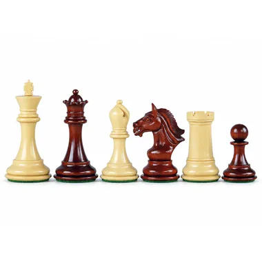 Chess pieces in boxwood and padauk, dark queen facing the light pieces