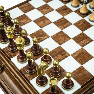 Detail of pawns and wood and brass pieces on marble and wood squares