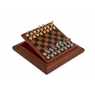 Complete chess set with gold and silver pieces on an open wooden board