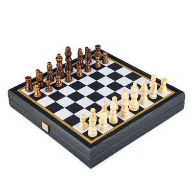 Chess board with wooden pieces set up for the start of a game