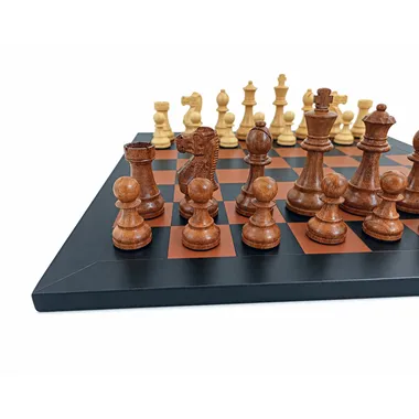 Dark acacia wood pieces viewed at a close angle on the leather chess board