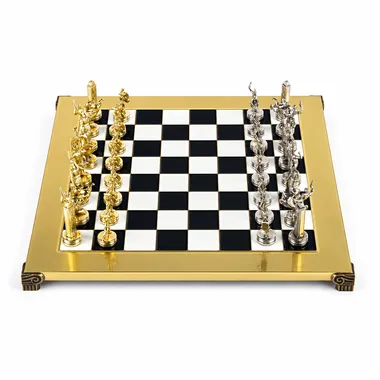 Gold-toned chess board viewed from the front with gold and silver pieces facing off