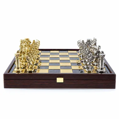 Chess board with gold and silver pieces facing off, box open