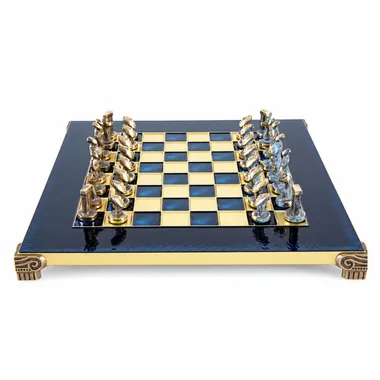 Blue and brass metal chess board with Art Cycladique pieces facing off