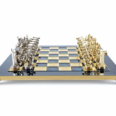 Blue and gold chessboard viewed from the front with gold and silver pieces lined up