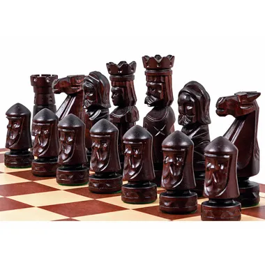 Dark pieces of the Château II chess set with carved faces