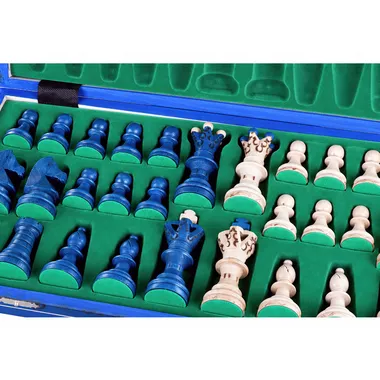 Blue and ivory chess pieces stored in their green storage box