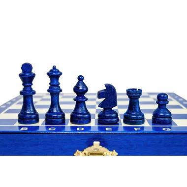 Close-up of dark blue Staunton pieces lined up on the board's edge