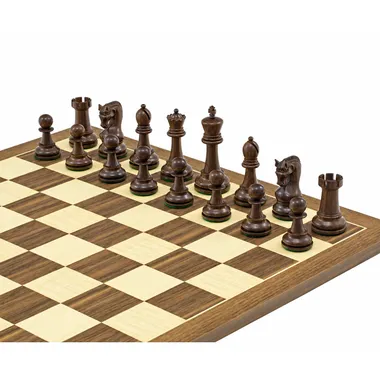 Dark acacia pieces lined up on the walnut and maple chess board, close-up view