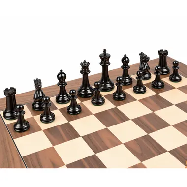 Black ebony pieces of the Staunton 1869 set lined up on the walnut chessboard