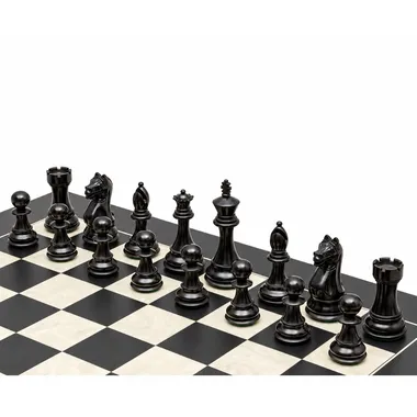 Ebonised black chess pieces lined up on the maple wood chess board