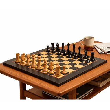 Chess set set up on a table in a warm living room with armchairs