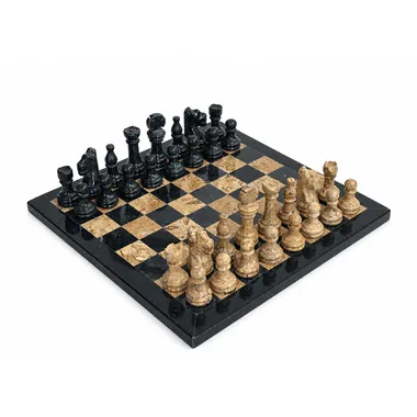 Chess set in black and beige marble, pieces set out on the board