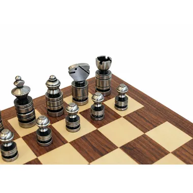 Detail of the contemporary dark silver chess pieces placed on the mahogany and maple chess board
