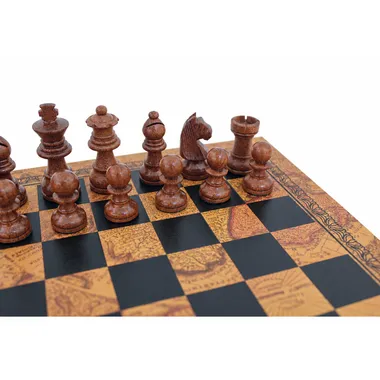 Close-up of dark acacia wood chess pieces on a vintage world map pattern board