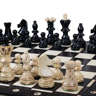 Chess set on a wooden board with black and white pieces - Le Palais Des Echecs